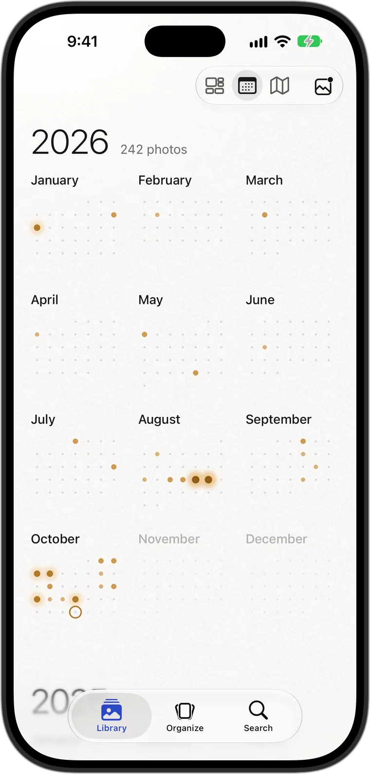 The Calendar’s year: each month a grid of days, the days with photos lit in gold.